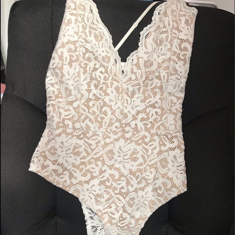 White lace body suit with clips at the bottom